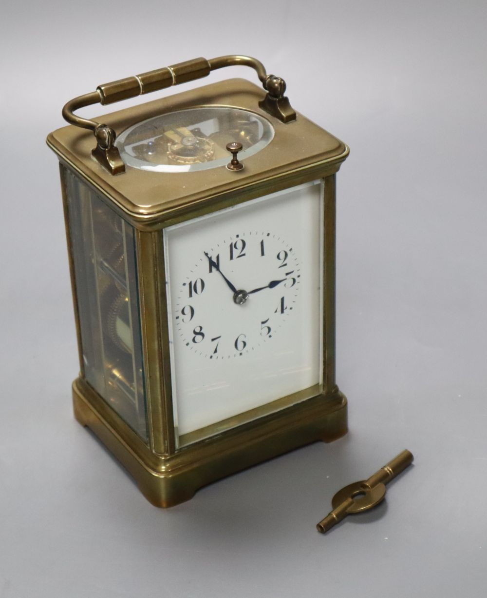 A French brass repeating carriage clock, enamelled dial, Obis case, height 18cm incl. handle